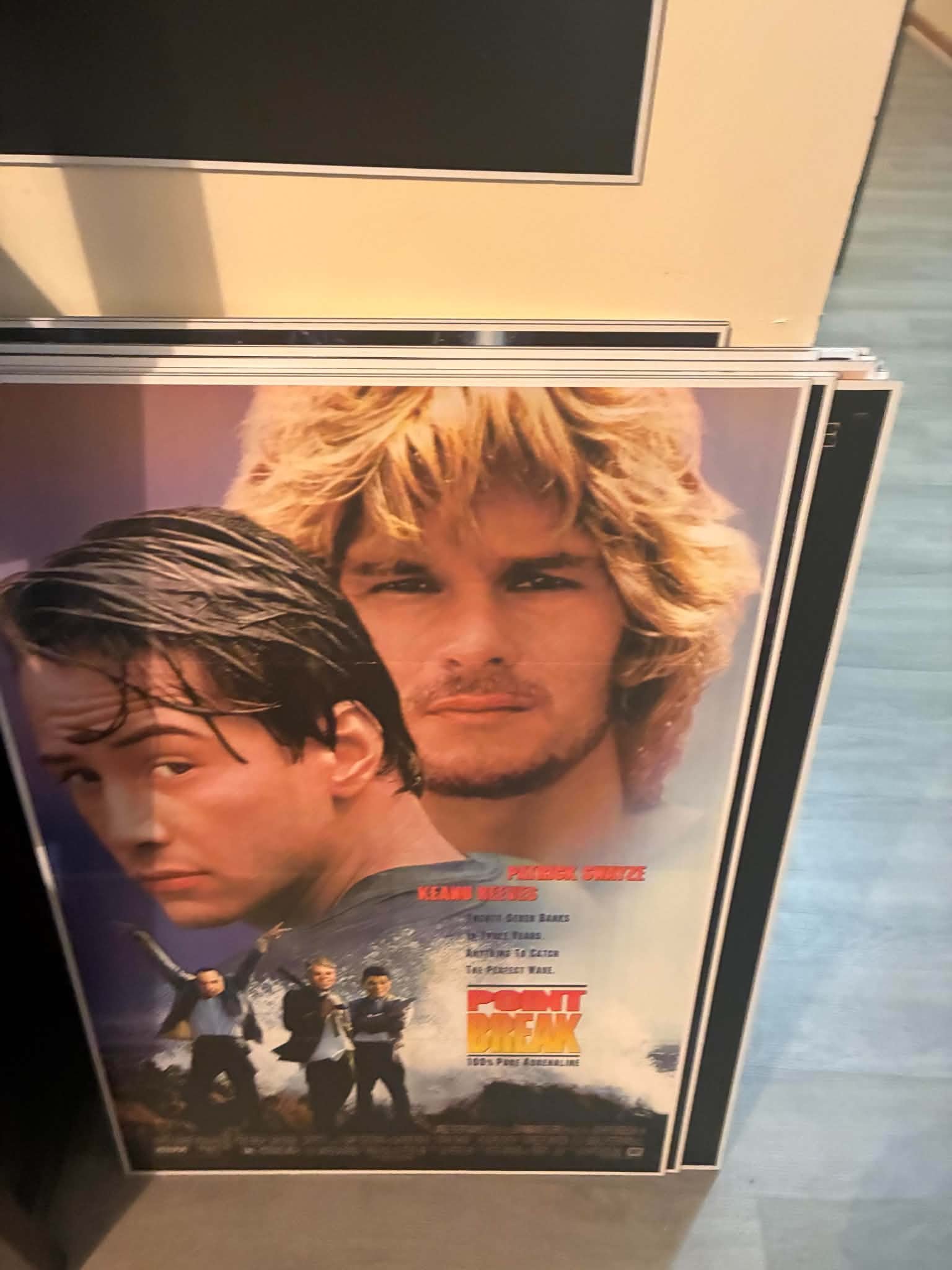 Photo of a Point Break poster print with Keanu Reeves and Patrick Swayze over the bank-robbing surfer crew martini lineup